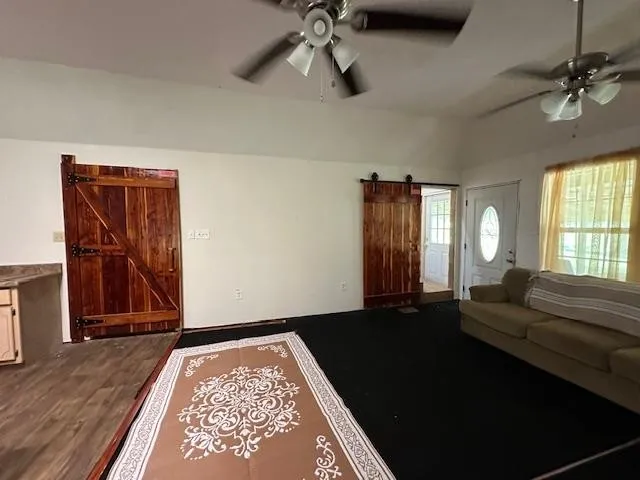 a kitchen with stainless steel appliances wooden floor dining table and chairs
