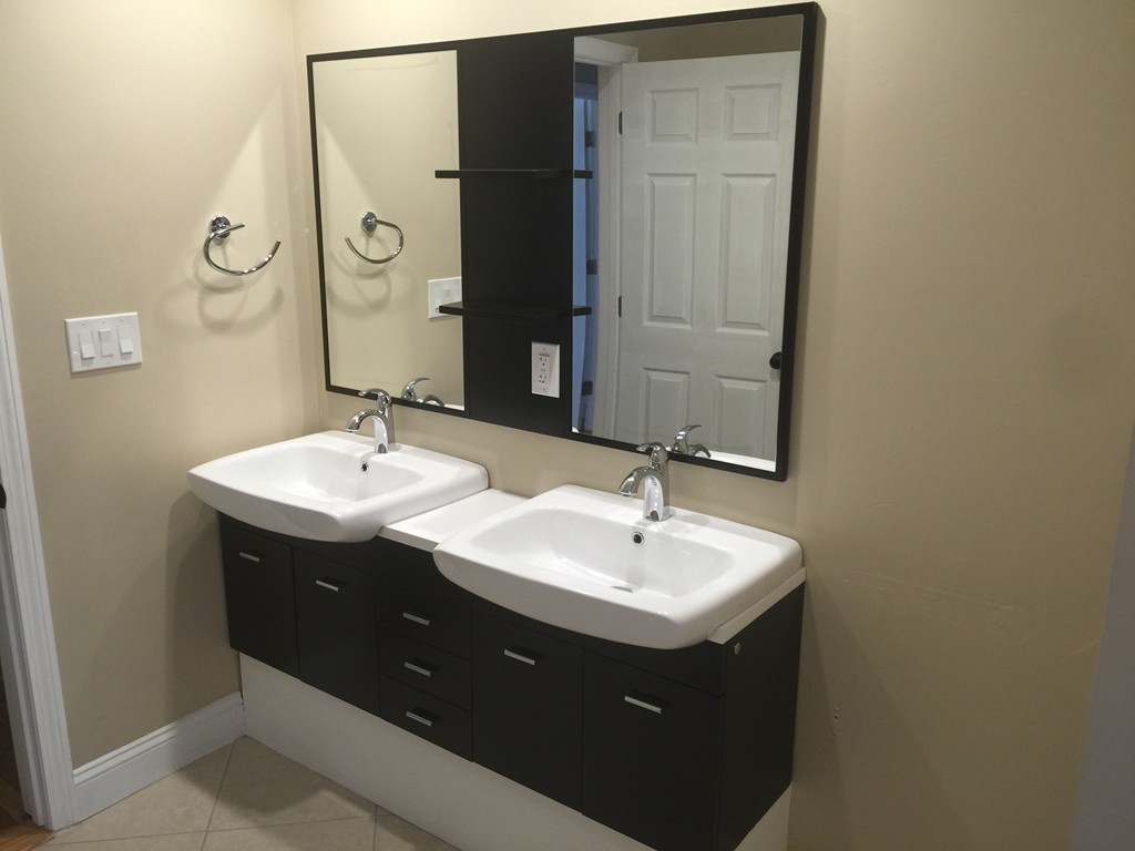 28 Bulfinch Terrace Lynn, MA 01902 - Photo 11 of 30 a bathroom with a sink and mirror