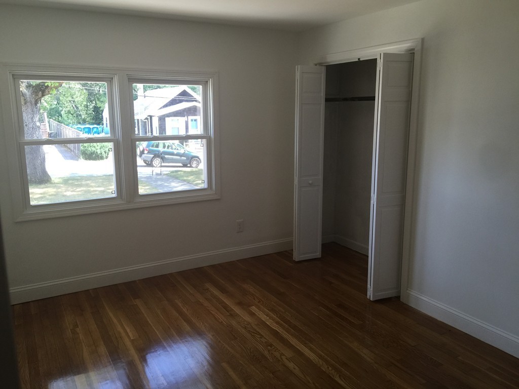 28 Bulfinch Terrace Lynn, MA 01902 - Photo 14 of 30 an empty room with wooden floor and windows