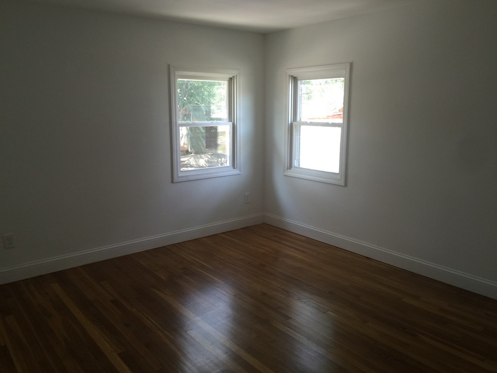 28 Bulfinch Terrace Lynn, MA 01902 - Photo 17 of 30 an empty room with wooden floor and windows