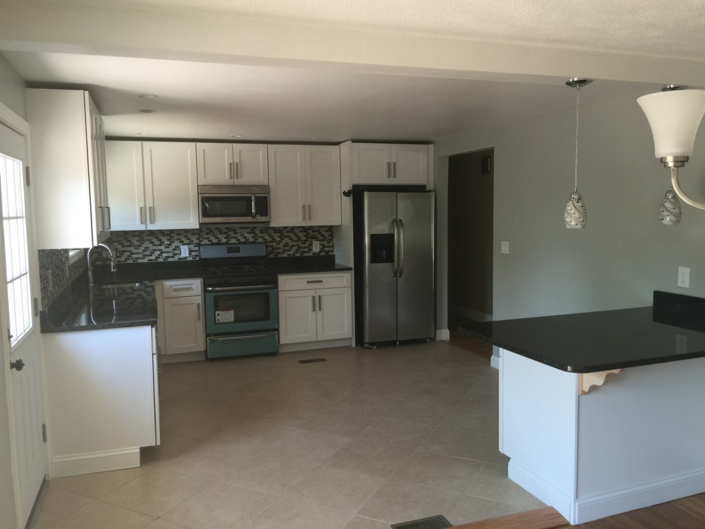 28 Bulfinch Terrace Lynn, MA 01902 - Photo 8 of 30 a kitchen with stainless steel appliances a refrigerator and a stove