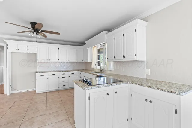 a kitchen with granite countertop white cabinets white appliances and granite counter tops