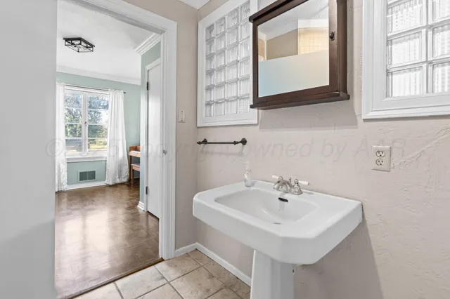 a bathroom with a sink and a mirror