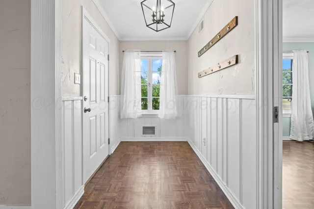 a view of a hallway with wooden floor and stairs