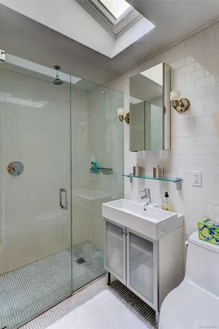 a bathroom with a sink toilet and shower