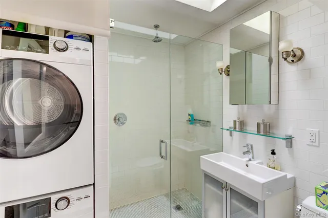 a bathroom with a sink a toilet and a mirror