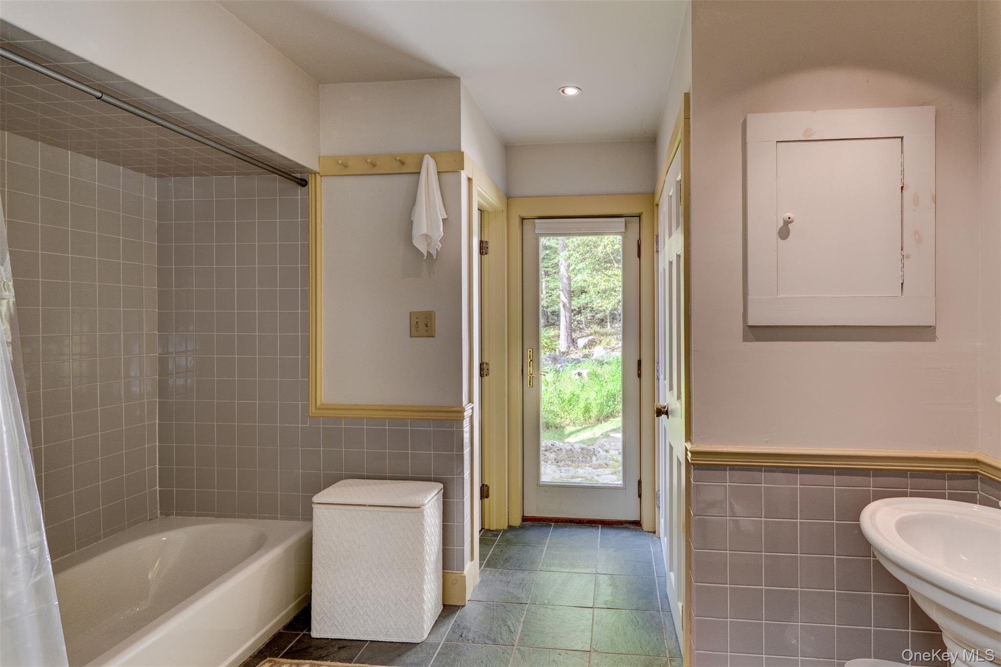 182 Lcpl Jacob Beisel Road Lackawaxen, PA 18435 - Photo 24 of 35 Bathroom with tile walls, a wainscoted wall, bathing tub / shower combination, and recessed lighting