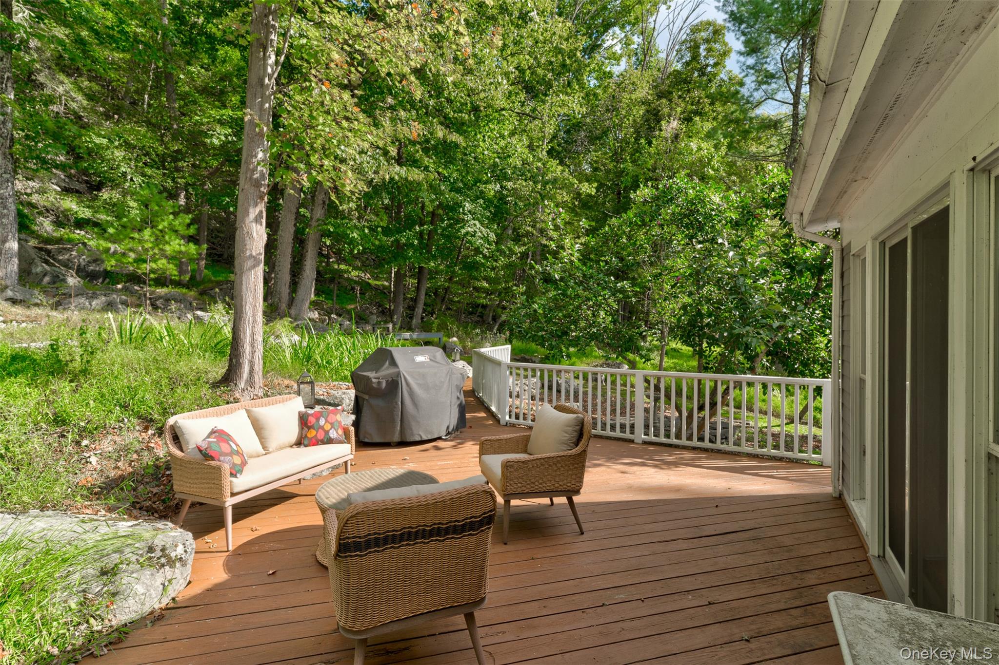 182 Lcpl Jacob Beisel Road Lackawaxen, PA 18435 - Photo 25 of 35 Deck with a grill, an outdoor hangout area, and view of wooded area