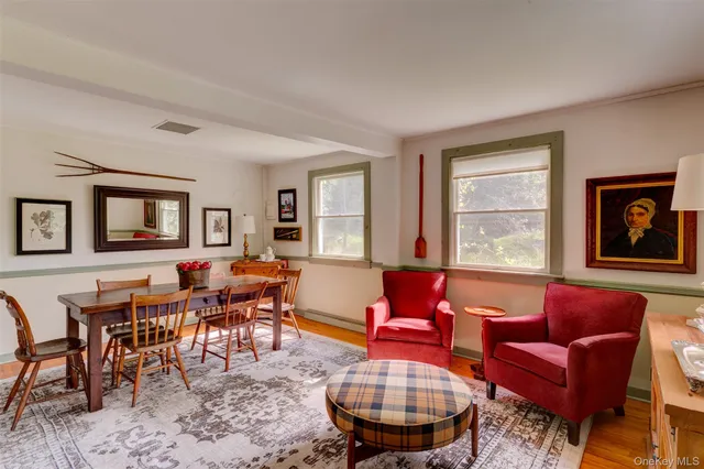a living room with furniture kitchen view and a window