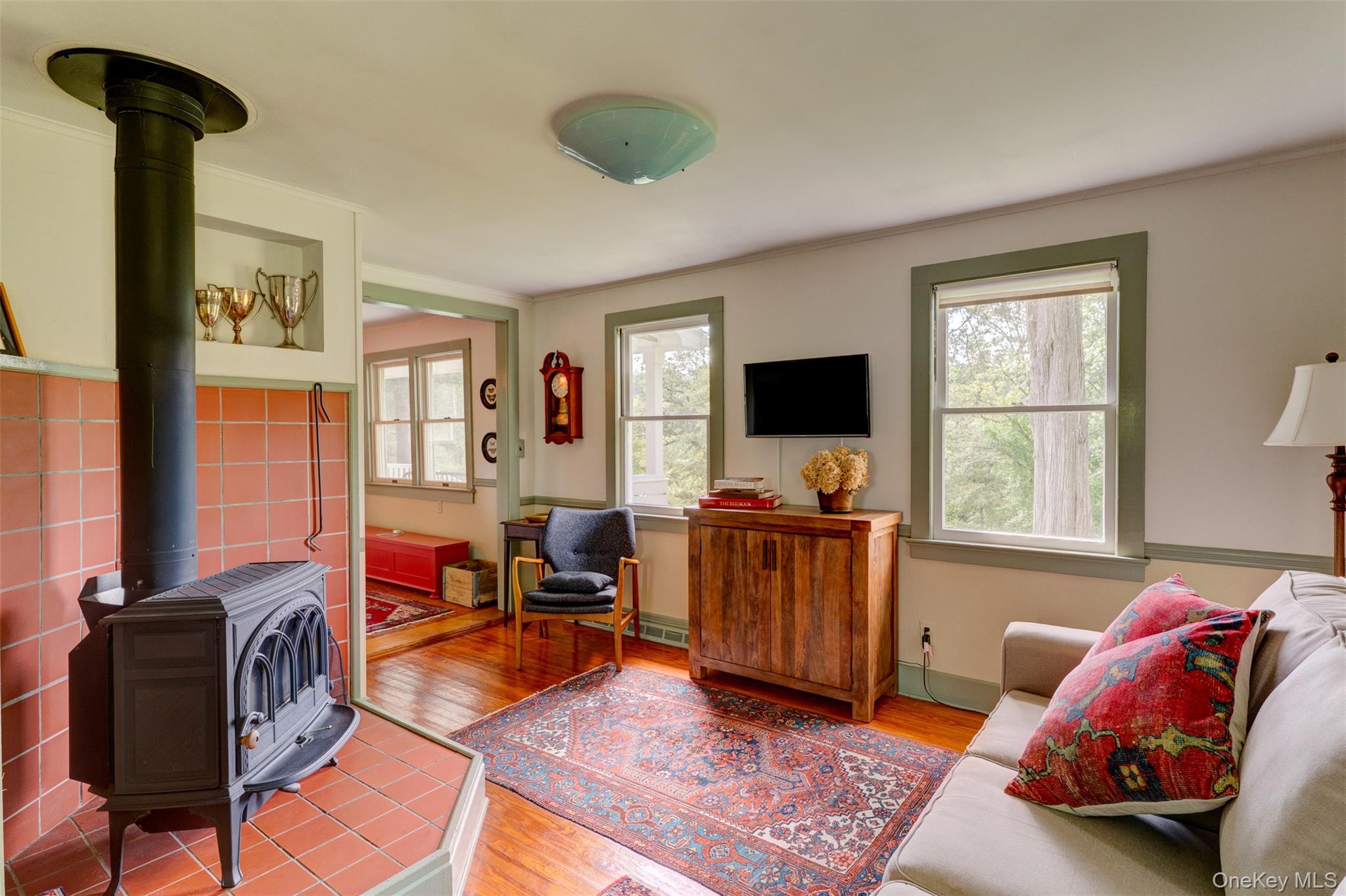 182 Lcpl Jacob Beisel Road Lackawaxen, PA 18435 - Photo 10 of 35 Living area featuring a wood stove, wood finished floors, and ornamental molding