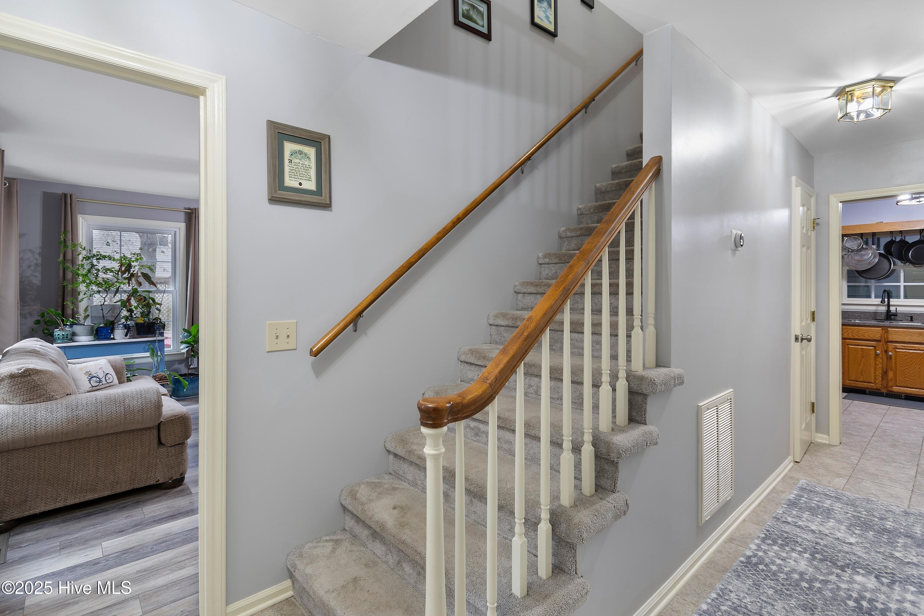 103 Ridge Road Hampstead, NC 28443 - Photo 17 of 60 Entryway - Downstairs Ensuite, Stairs To Upstairs, Hallway to 1/2 Bath and Kitchen and Doorway to Living Room!