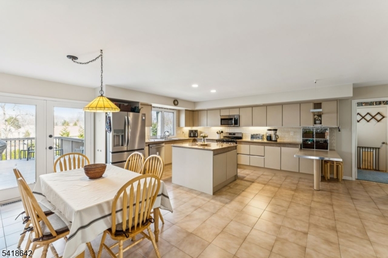 11 North Ridge Road Denville, NJ 07834 - Photo 12 of 43 a kitchen with a table chairs microwave and cabinets