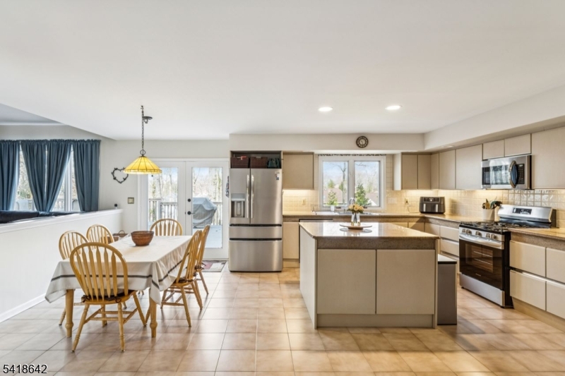 11 North Ridge Road Denville, NJ 07834 - Photo 13 of 43 a kitchen with a dining table chairs stainless steel appliances and cabinets