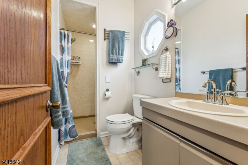 11 North Ridge Road Denville, NJ 07834 - Photo 23 of 43 a bathroom with a sink a toilet and a mirror