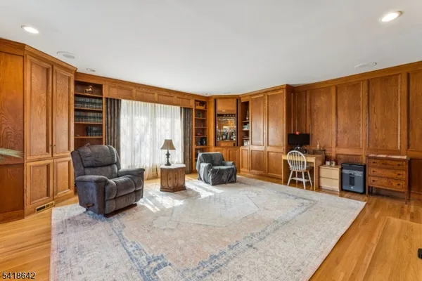 a living room with furniture and large windows