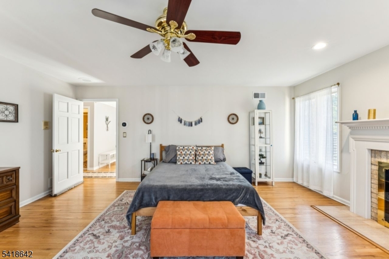 11 North Ridge Road Denville, NJ 07834 - Photo 30 of 43 a bedroom with a bed and a chandelier