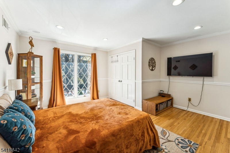 11 North Ridge Road Denville, NJ 07834 - Photo 38 of 43 a spacious bedroom with a bed and a flat screen tv