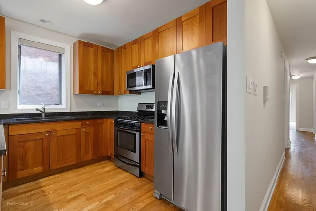 a kitchen with stainless steel appliances granite countertop a refrigerator and a sink