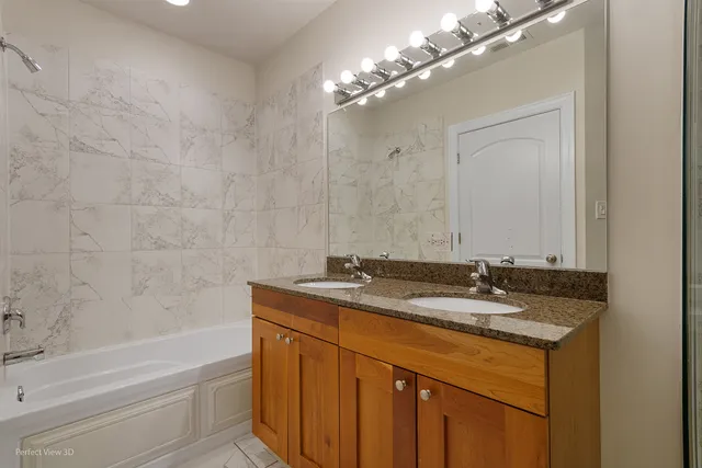 a bathroom with a granite countertop sink a toilet and bathtub