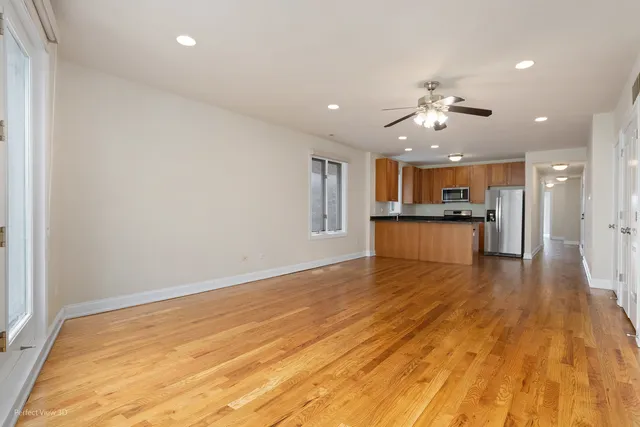 a view of a kitchen with a sink and wooden floor