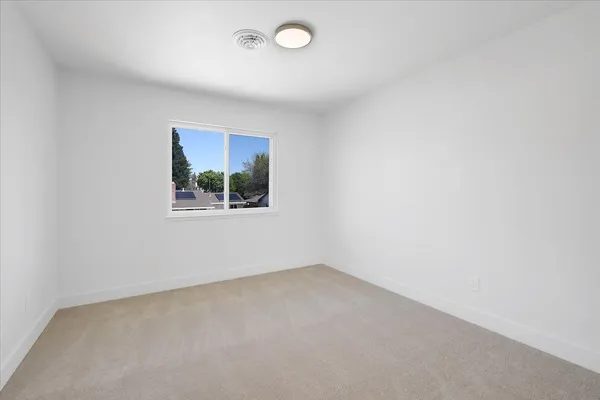a view of roof deck with two couches and wooden floor