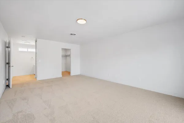 a view of a house with backyard and wooden fence
