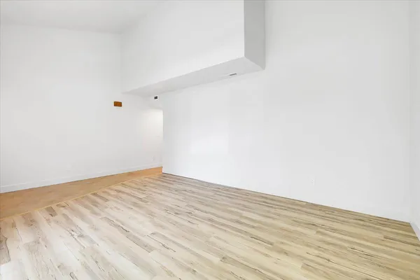 a kitchen with stainless steel appliances a sink a counter top space cabinets and a window