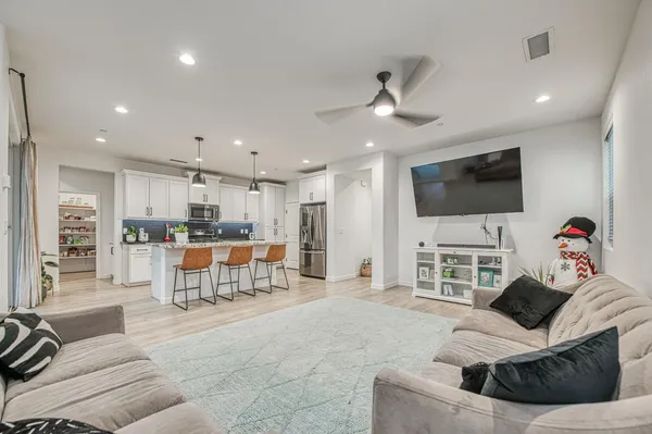 a kitchen with kitchen island granite countertop a sink a counter space appliances and cabinets