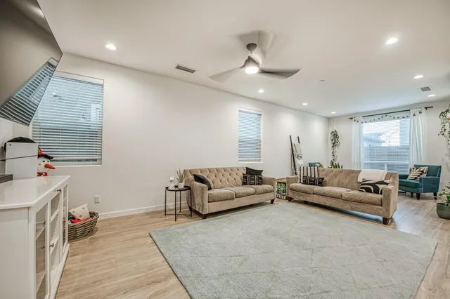 a kitchen with stainless steel appliances granite countertop a stove a sink a microwave a island with a dining table and chairs