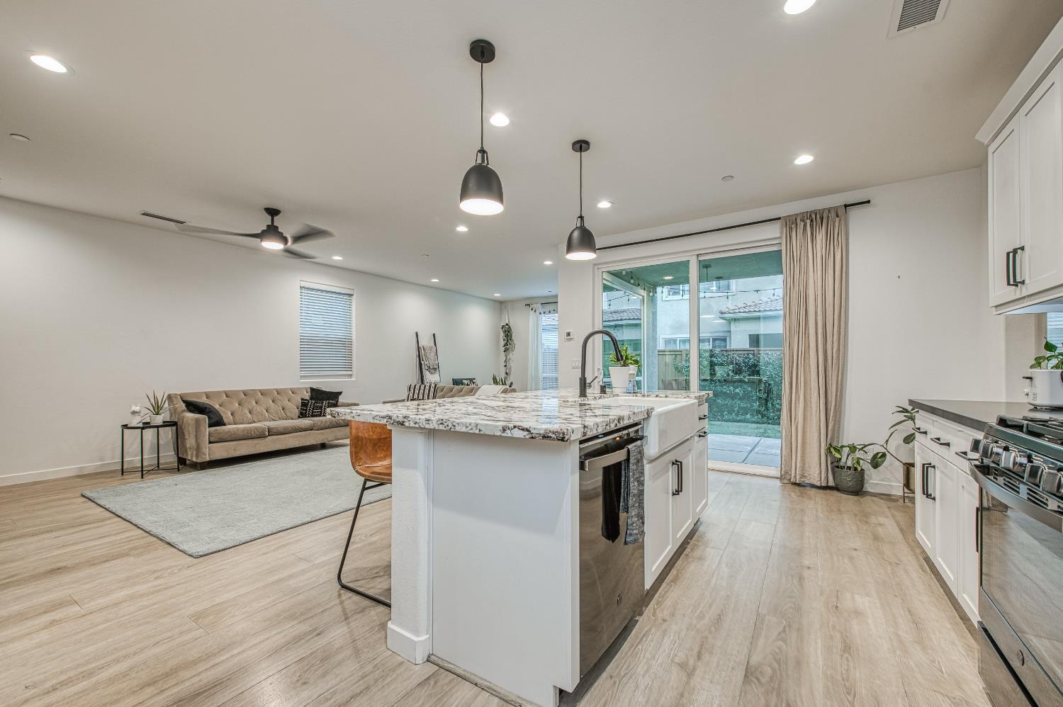 4311 San Miguel Road Madera, CA 93636 - Photo 19 of 79 a kitchen with stainless steel appliances granite countertop a lot of counter space and wooden floors