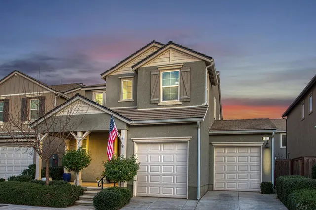 a front view of a house with garage
