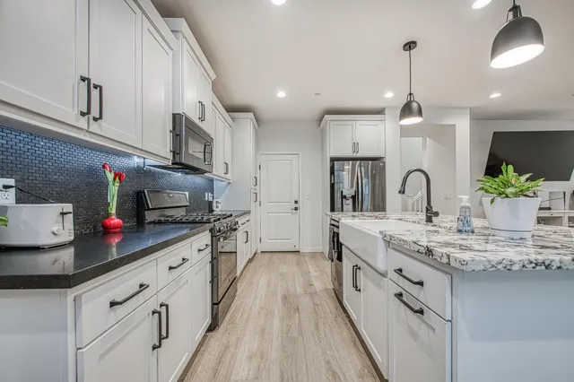 a bathroom with a granite countertop sink mirror and double