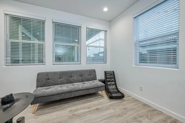 a bedroom with a bed a flat screen tv and dresser