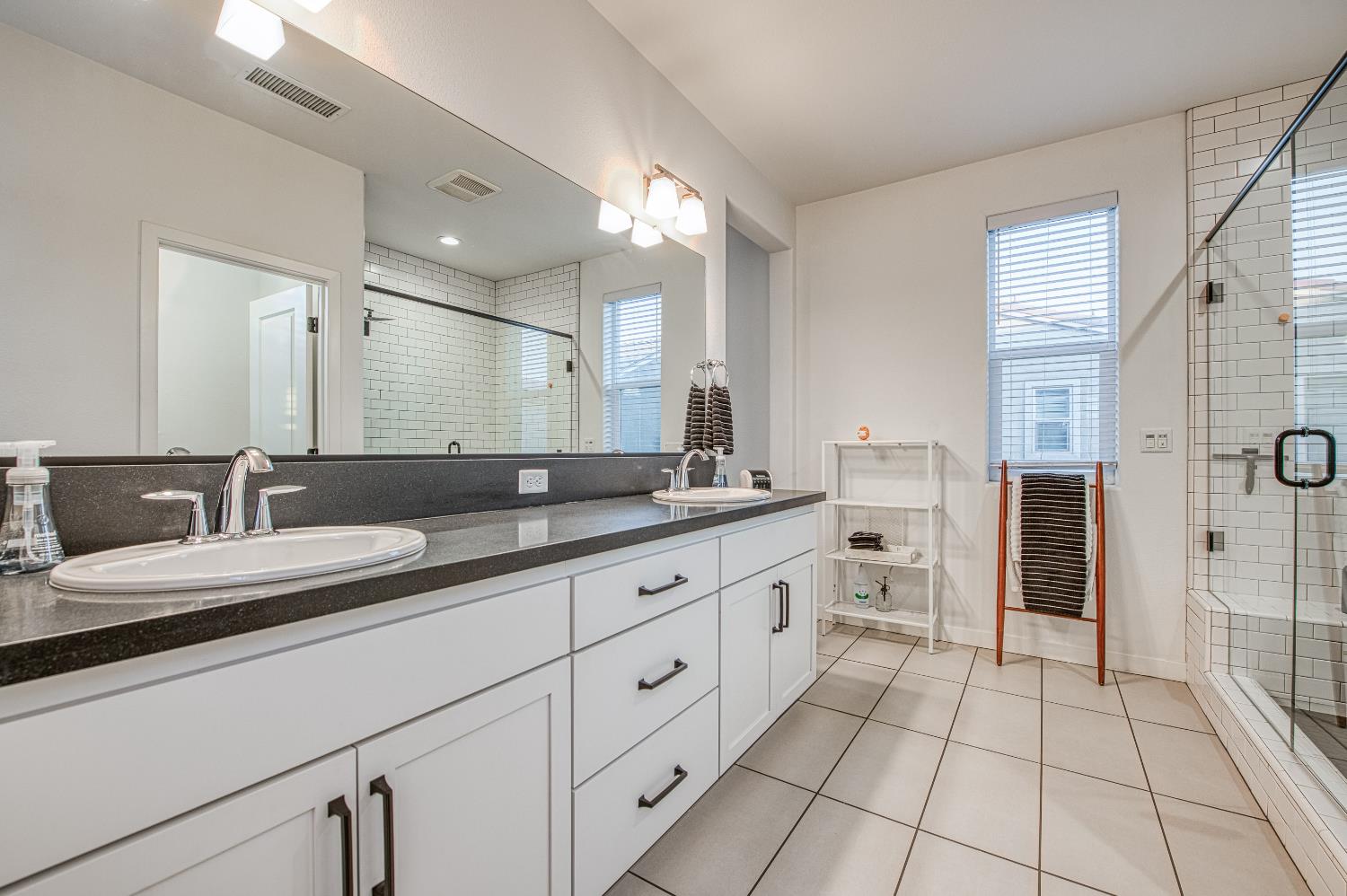 4311 San Miguel Road Madera, CA 93636 - Photo 34 of 79 a bathroom with a granite countertop sink mirror and double