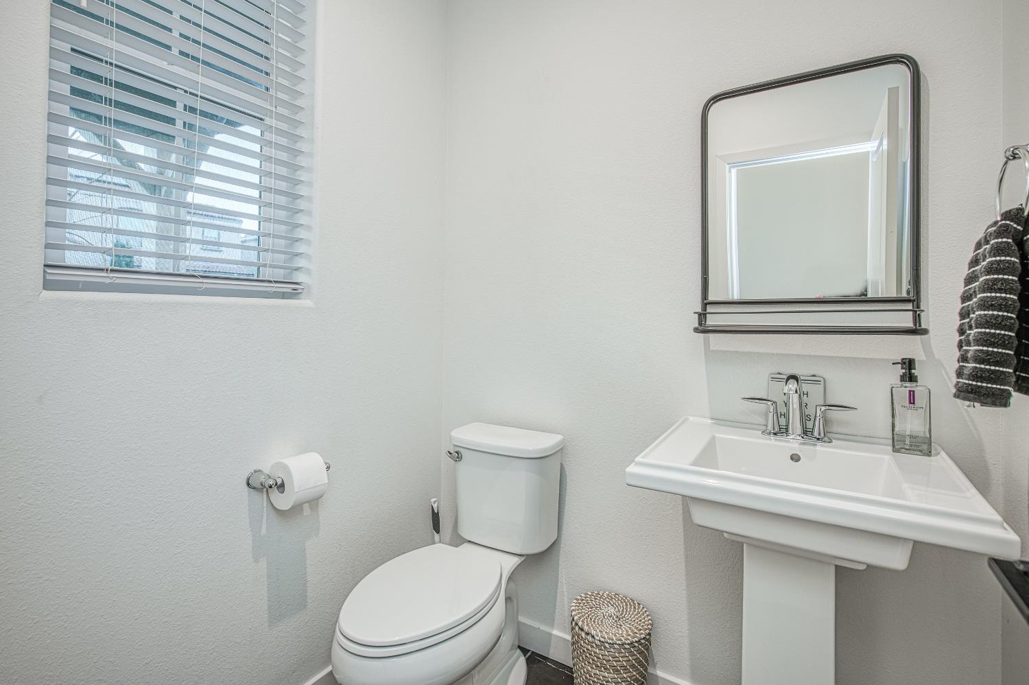 4311 San Miguel Road Madera, CA 93636 - Photo 57 of 79 a bathroom with a toilet a sink and mirror