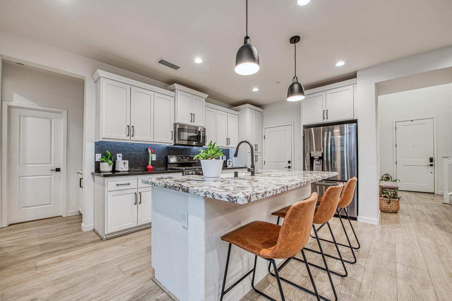 4311 San Miguel Road Madera, CA 93636 - Photo 7 of 79 a kitchen with stainless steel appliances granite countertop a stove refrigerator and cabinets