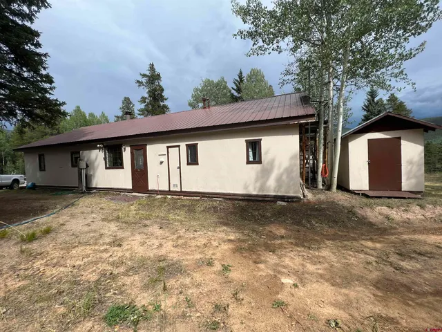 a view of a house with a yard and garage