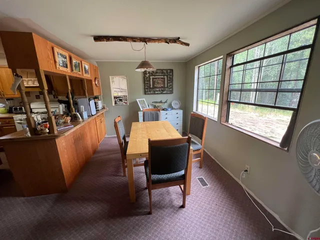 a dining room with furniture and a window