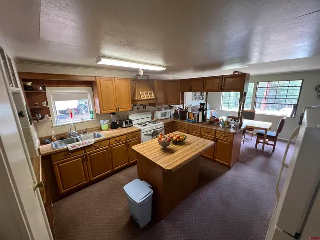 a kitchen with a sink stove and cabinets