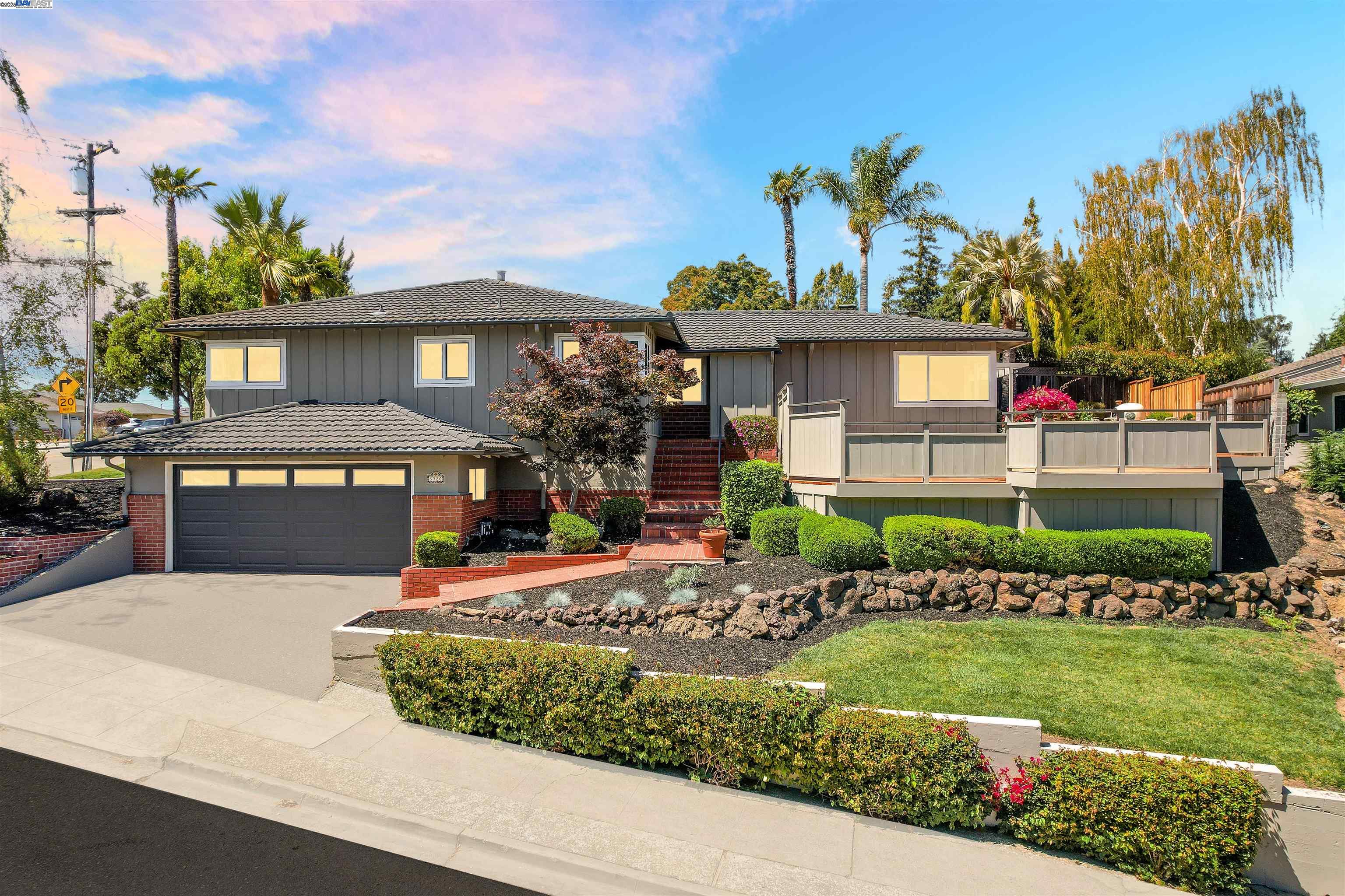 a front view of a house with a garden and a yard