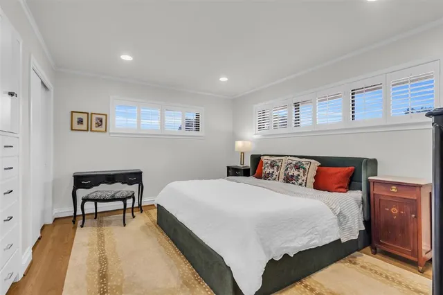 a bedroom with a bed and a chair