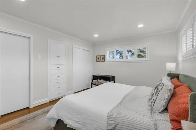 a bedroom with a large bed and a chandelier