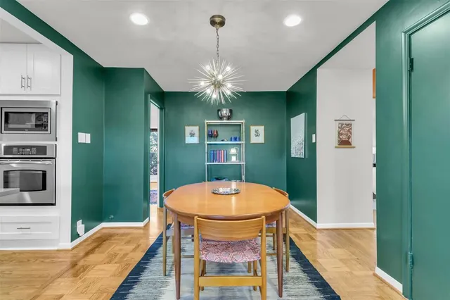 a view of a dining room with furniture and chandelier
