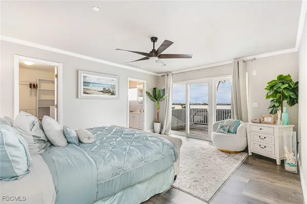 a view of a livingroom with wooden floor and a ceiling fan