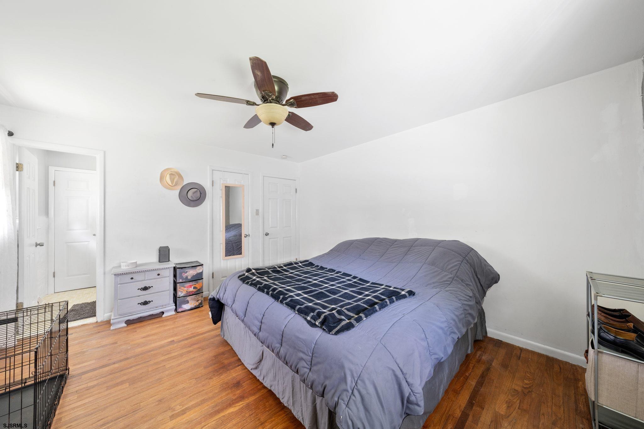 40 Gulph Mill Road Somers Point, NJ 08244 - Photo 11 of 21 a bedroom with a bed and a chandelier