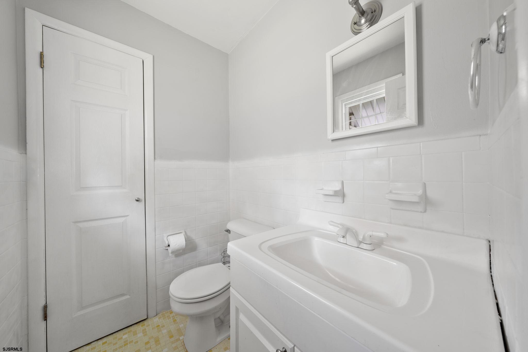 40 Gulph Mill Road Somers Point, NJ 08244 - Photo 12 of 21 a bathroom with a sink toilet and mirror