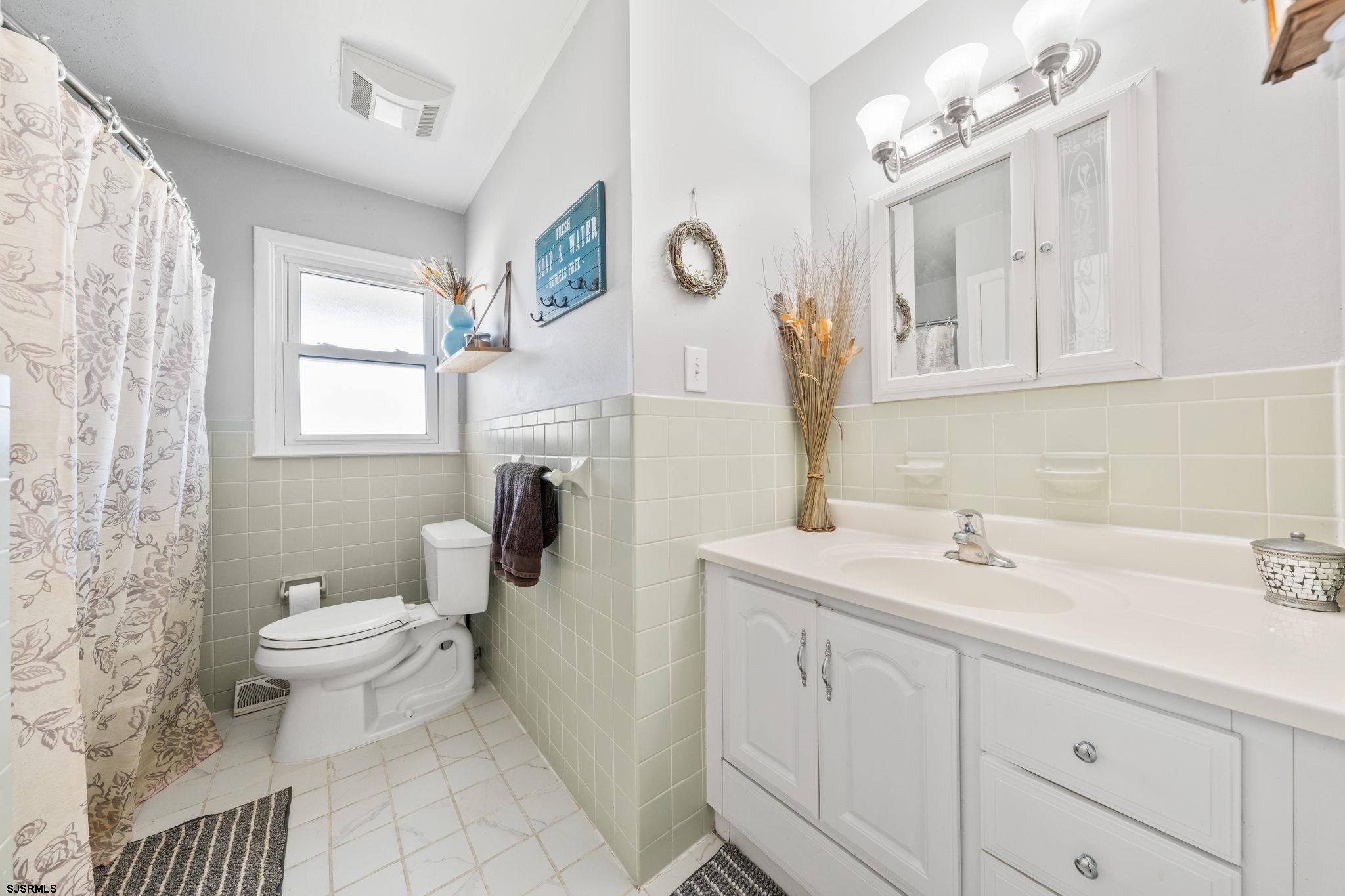 40 Gulph Mill Road Somers Point, NJ 08244 - Photo 15 of 21 a bathroom with a sink a toilet and mirror