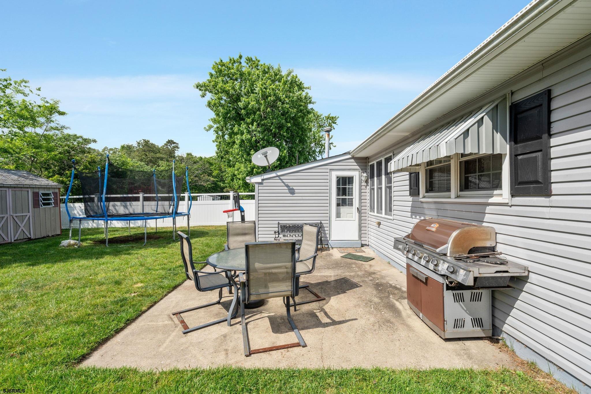 40 Gulph Mill Road Somers Point, NJ 08244 - Photo 21 of 21 a backyard of a house with table and chairs