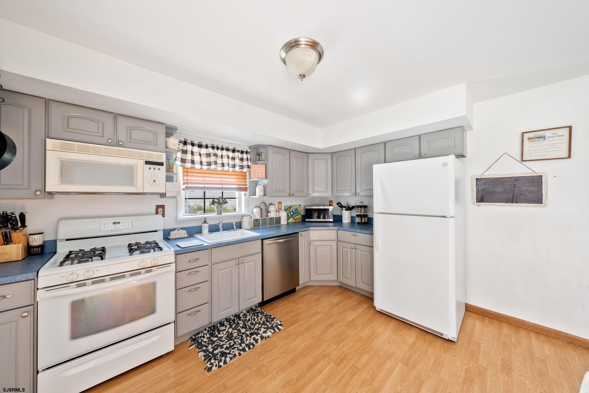 40 Gulph Mill Road Somers Point, NJ 08244 - Photo 8 of 21 a kitchen with a white cabinets and white appliances