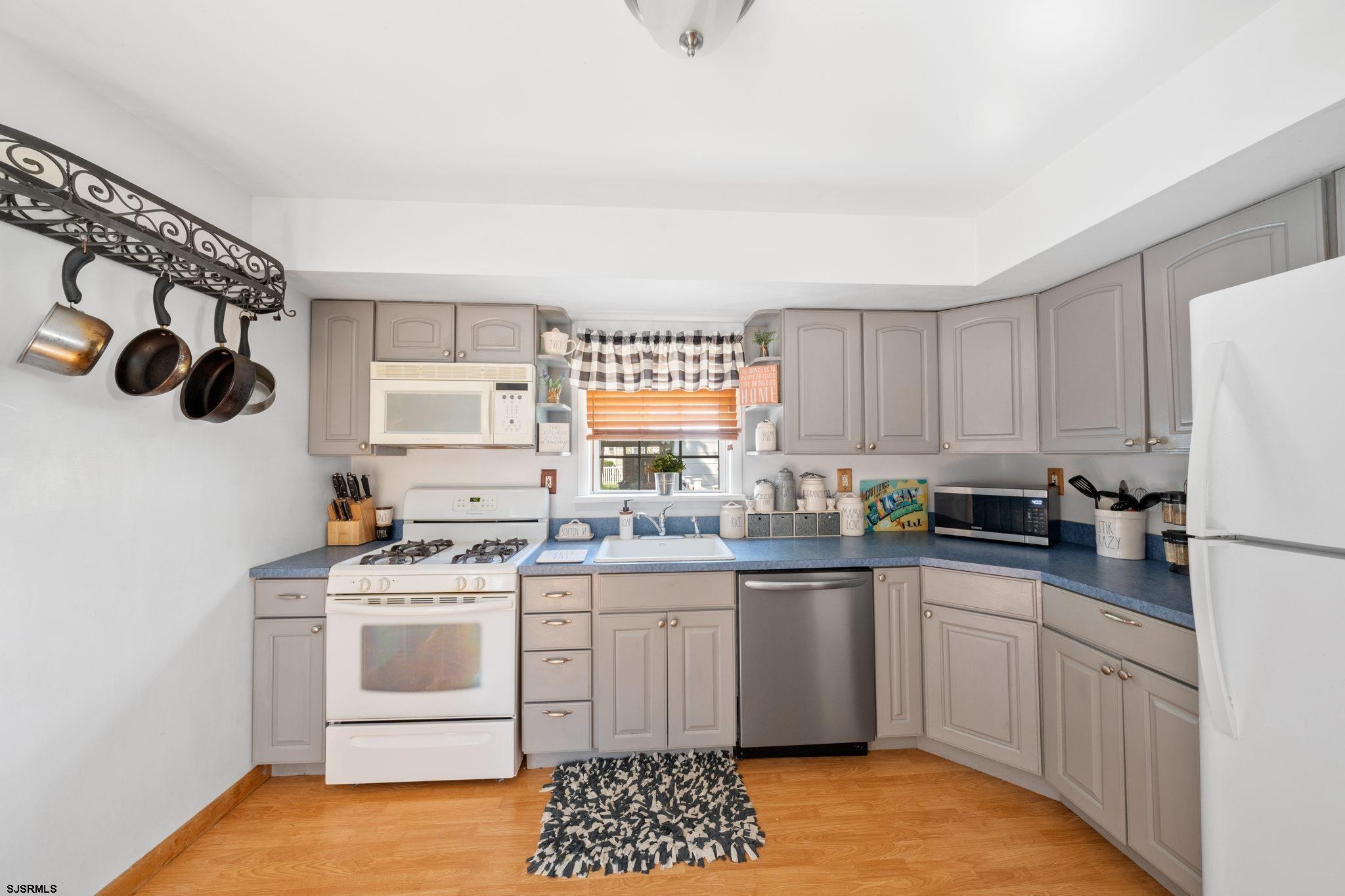 40 Gulph Mill Road Somers Point, NJ 08244 - Photo 9 of 21 a kitchen with a sink a stove and cabinets